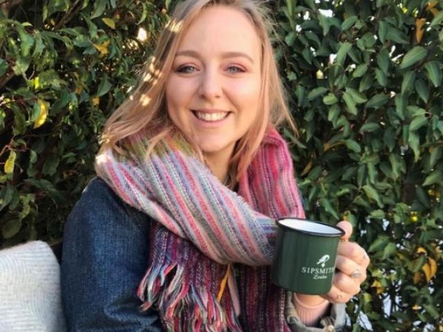 Emma Pestridge smiles with a cup of tea