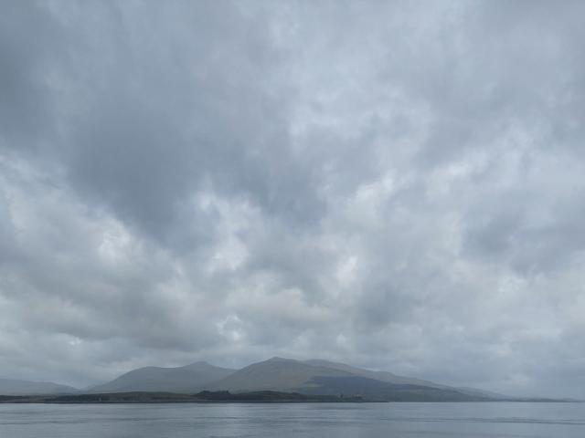 Grey view over the sea to the Isle of Mull