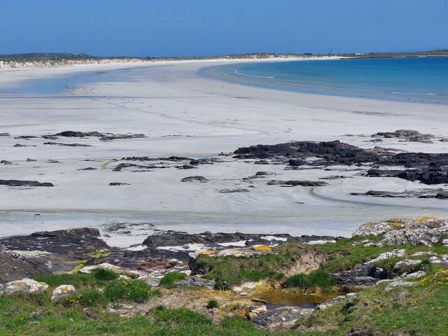 A beautiful white sandy beach and blue sea on the Isle of Tiree
